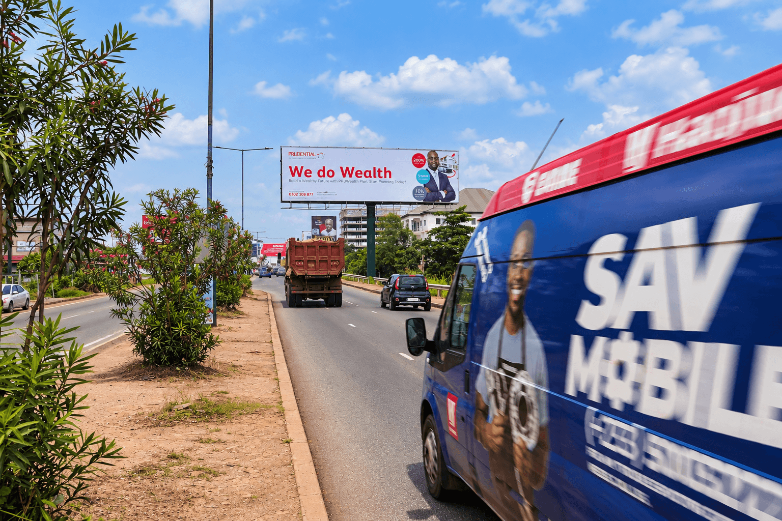 Large XMINGER roadside billboard above traffic in Ghana