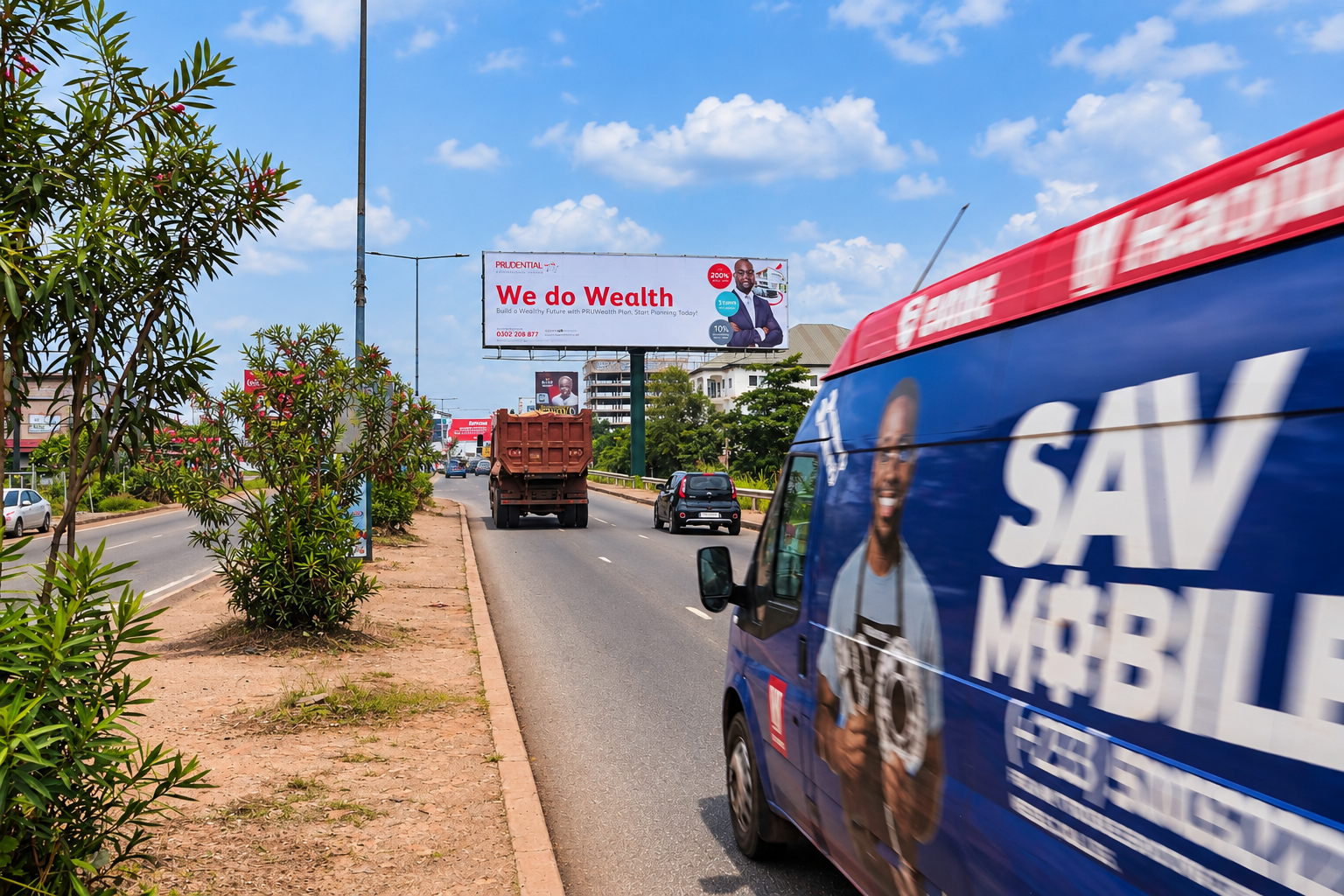 Large XMINGER roadside billboard above traffic in Ghana